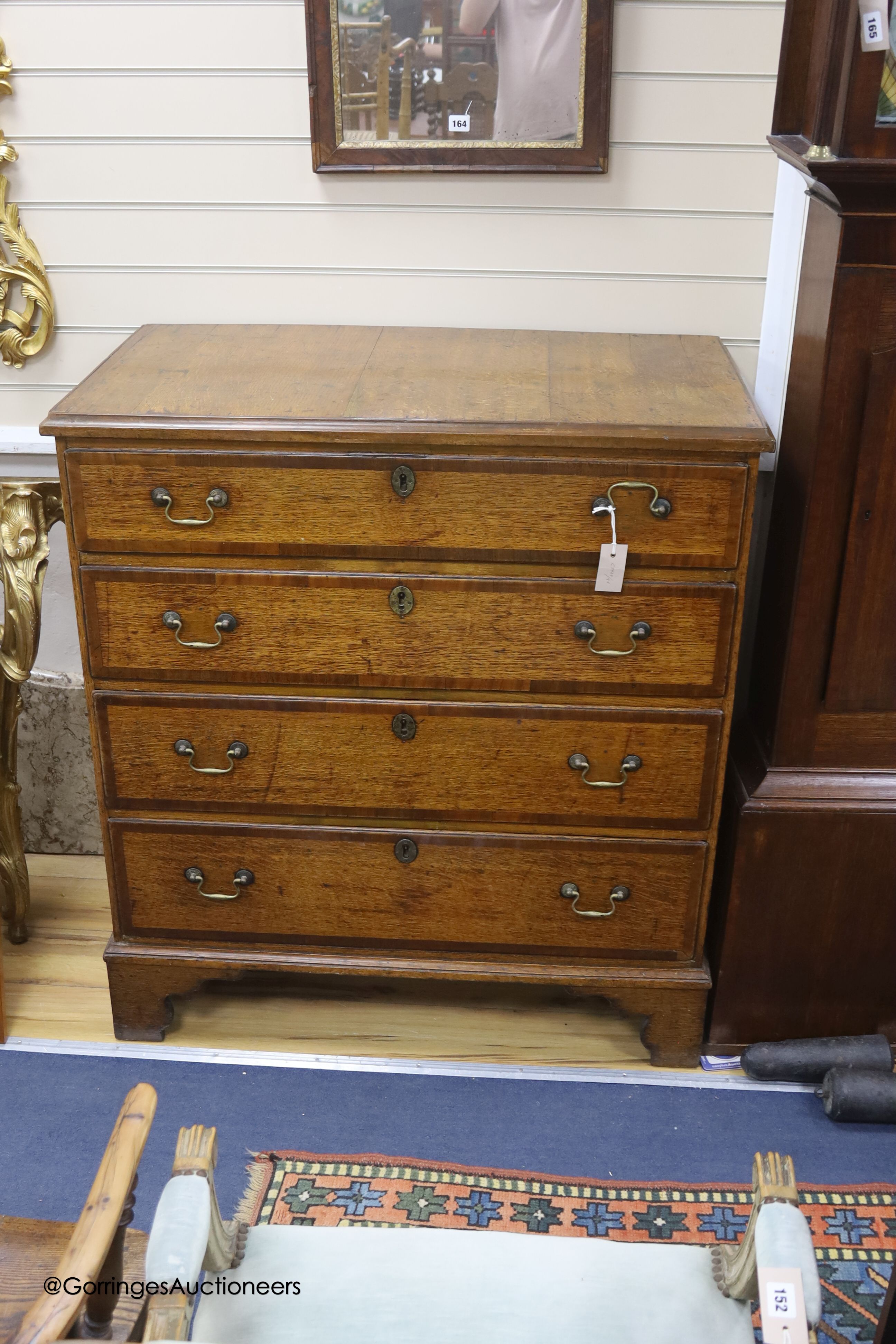 An 18th century oak chest of four graduated drawers